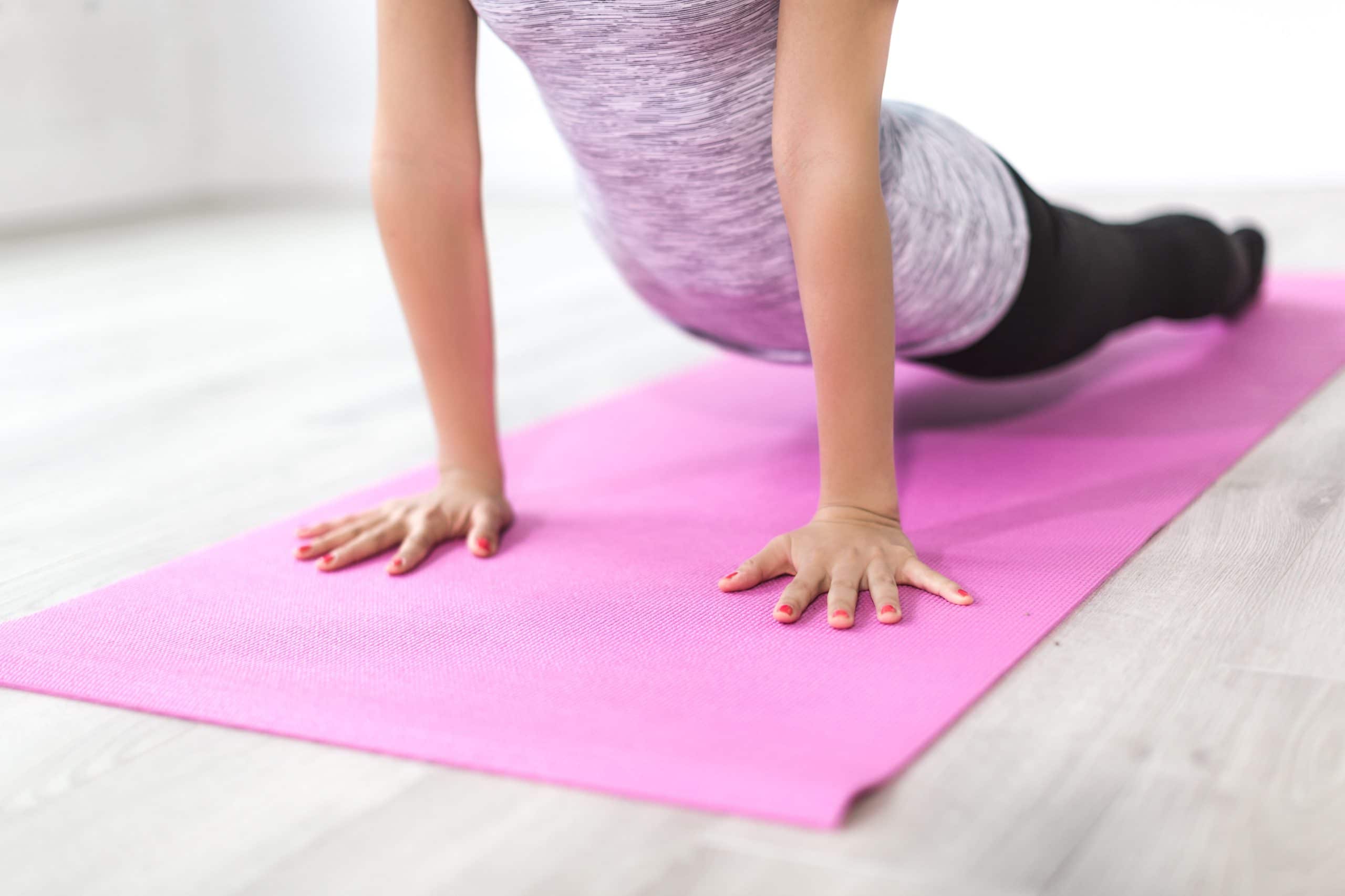 A woman is doing poses on her yoga mat health strategies