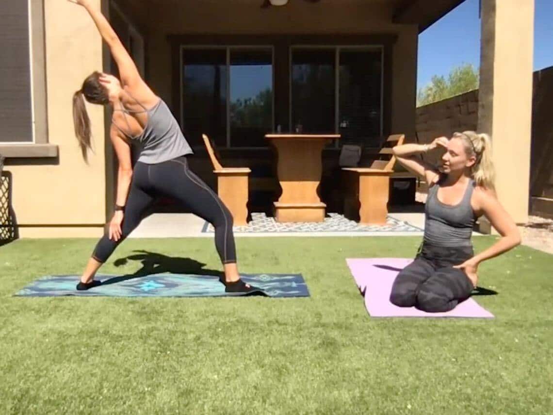 Two girls in the backyard doing yoga flow