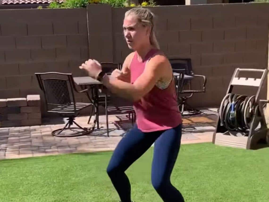 A woman doing a full body workout in her backyard
