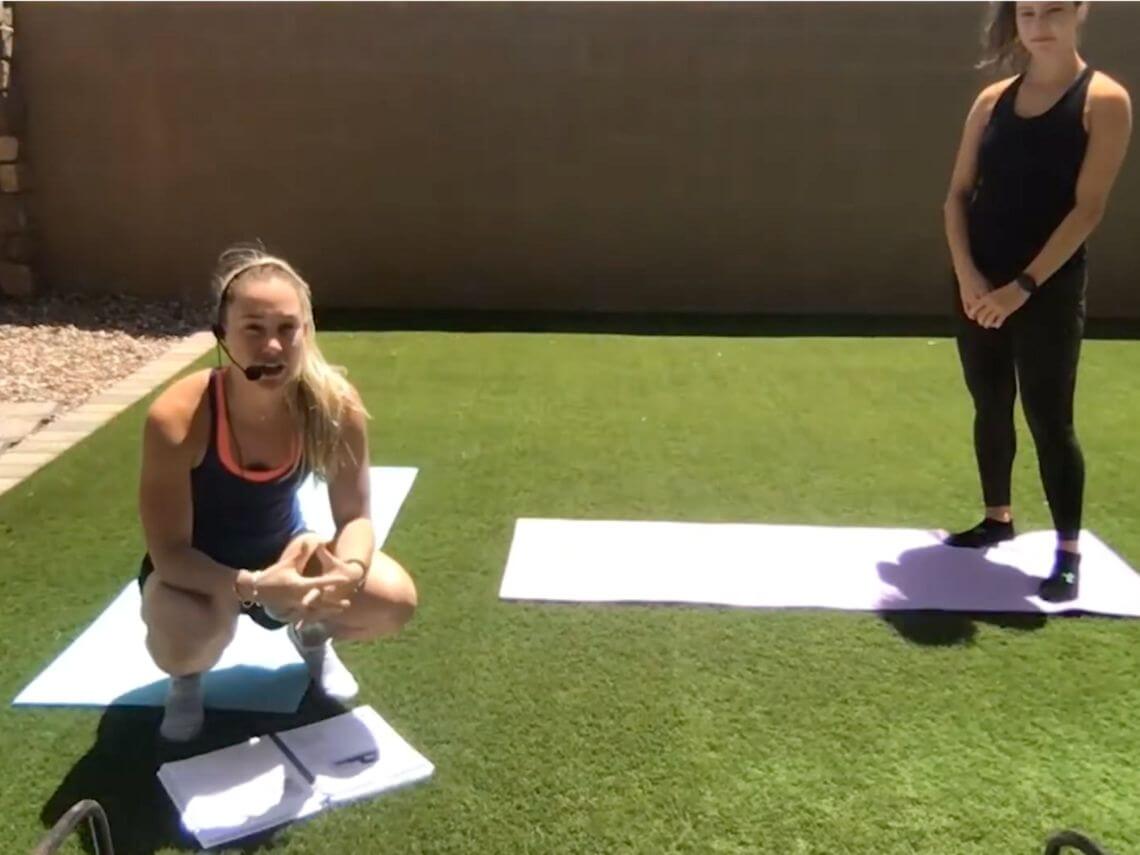 Two women in the backyard doing a yoga session