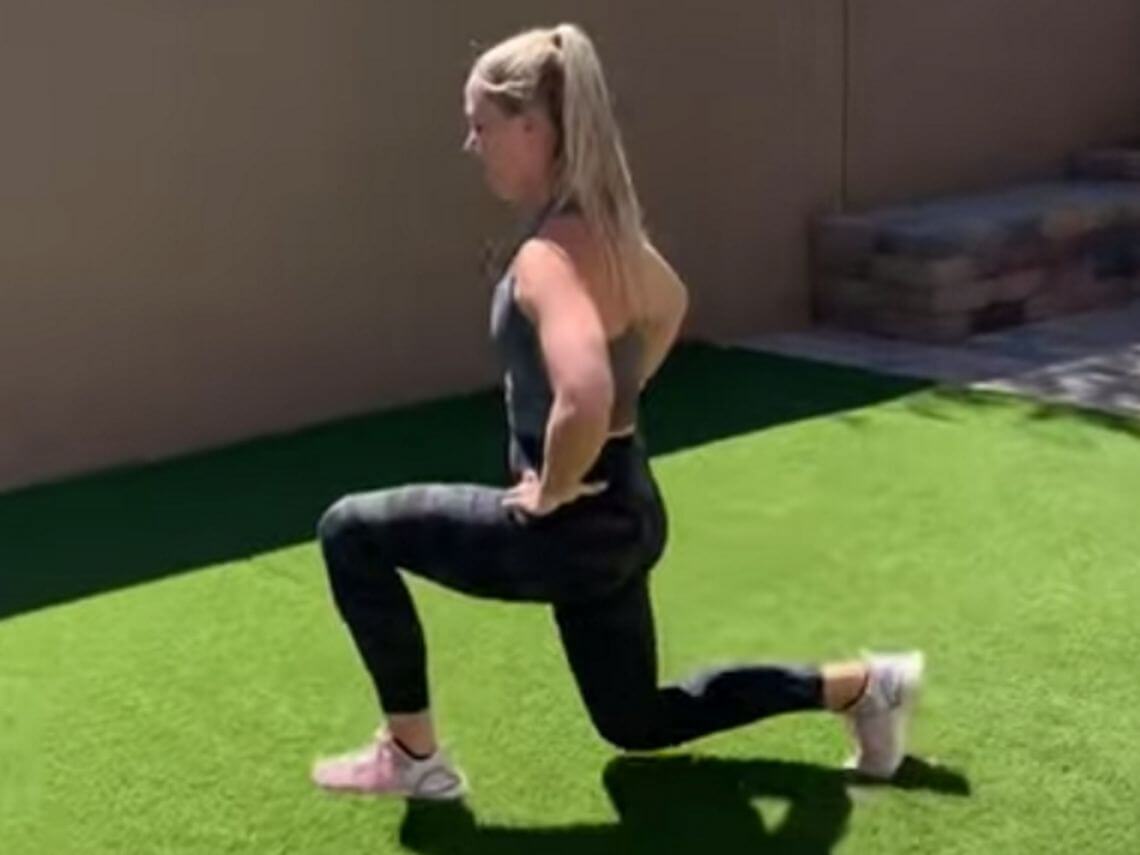 a female instructor doing a workout in her backyard