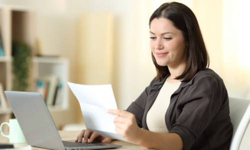 Women on computer looking at document