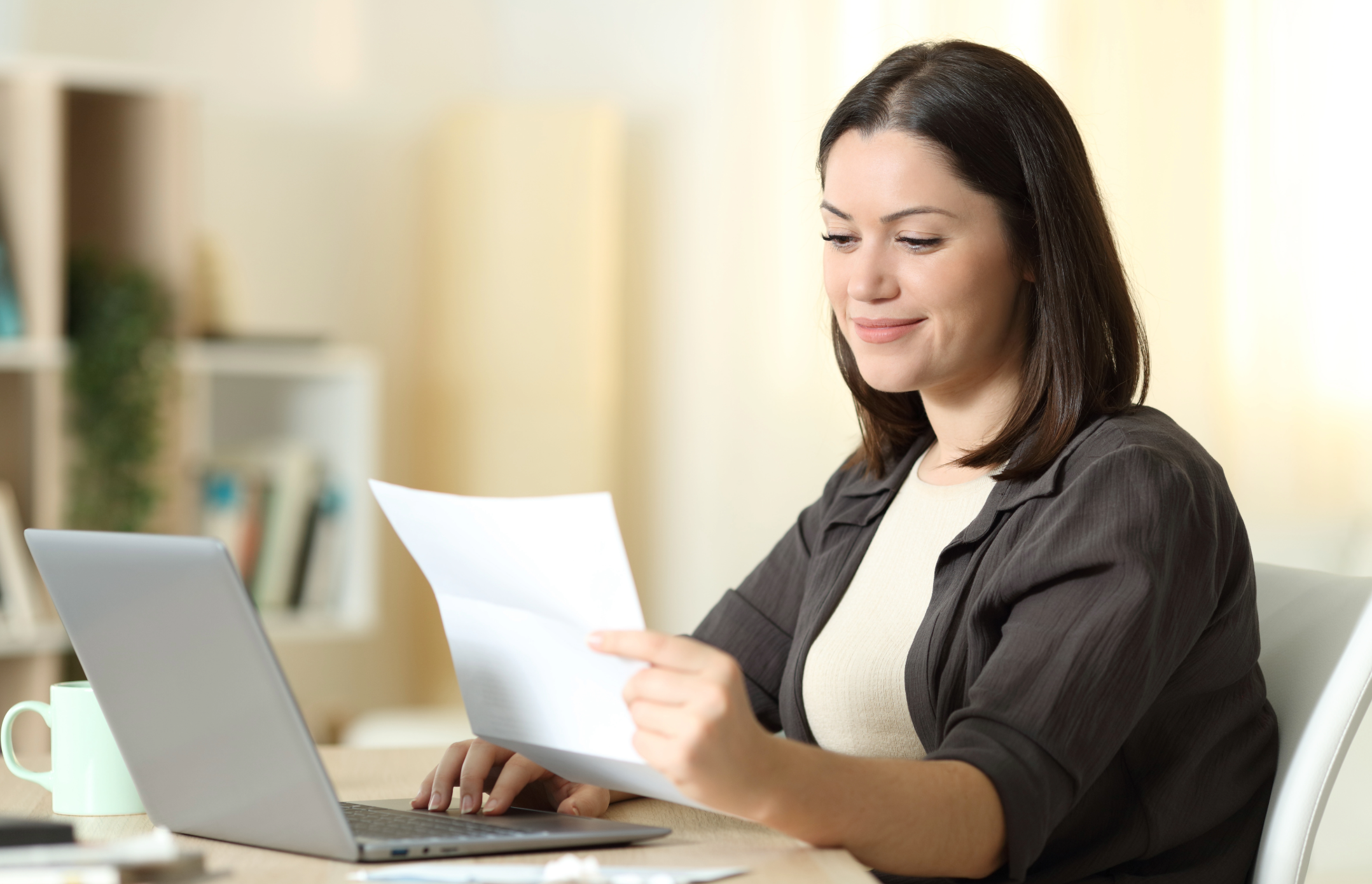 Women on computer looking at document